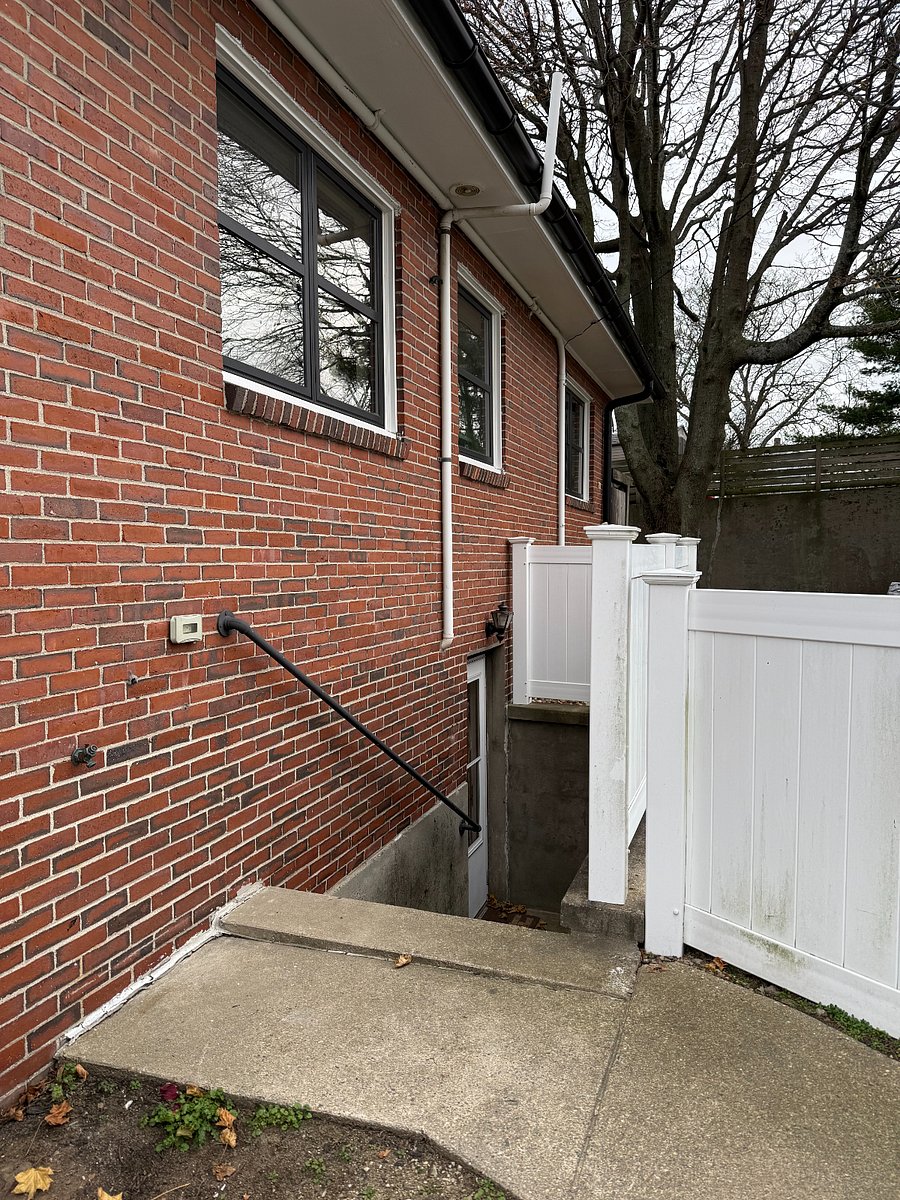 Private exterior entrance with well-lit pathway and easy street parking.