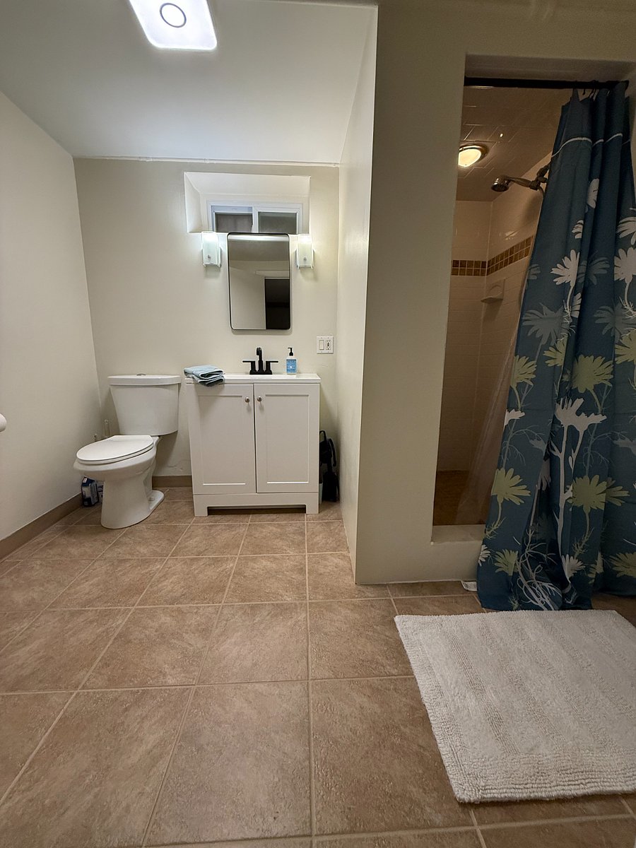 Spacious bathroom with walk in shower.