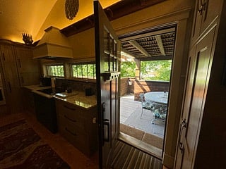The deck is right off of the kitchen, bringing the outdoor space inside and extending the indoor kitchen to the outside. 
