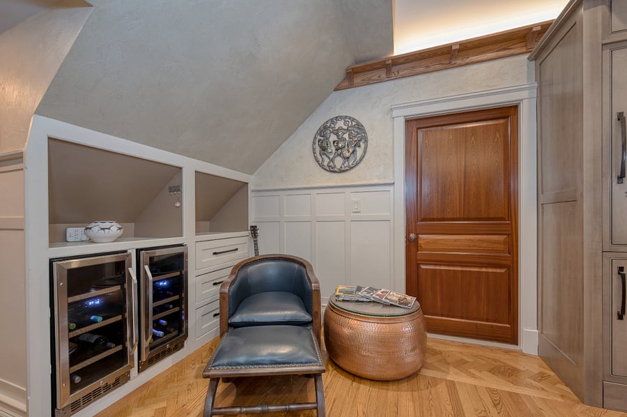 A separate area for sitting with wine cooler, additional drawers and shelving. The door accesses the laundry and bath area off the kitchen/sitting area