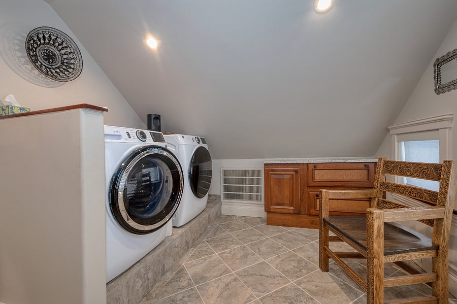 Full sized washer and dryer with towel cabinets provide ample space that is shared with the bath/shower/vanity/toilet area. 
