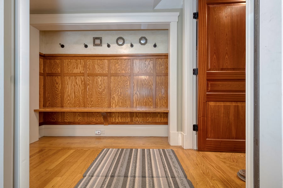 At the top of stair find mini "mudroom" and cubby for storage, to the left opens to a larger area for storage and an upright freezer. 