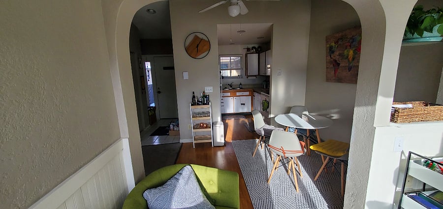 View from the nook towards the front entry hall overlooking the dining room and into the kitchen.