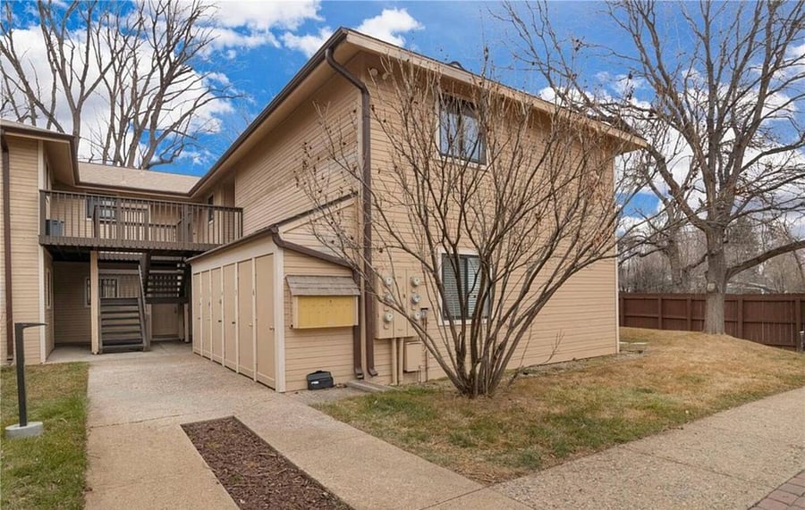 Outside of complex. 6 units in building. Unit located on second floor. Dedicated storage unit on ground floor (seen to the right before the stairs).