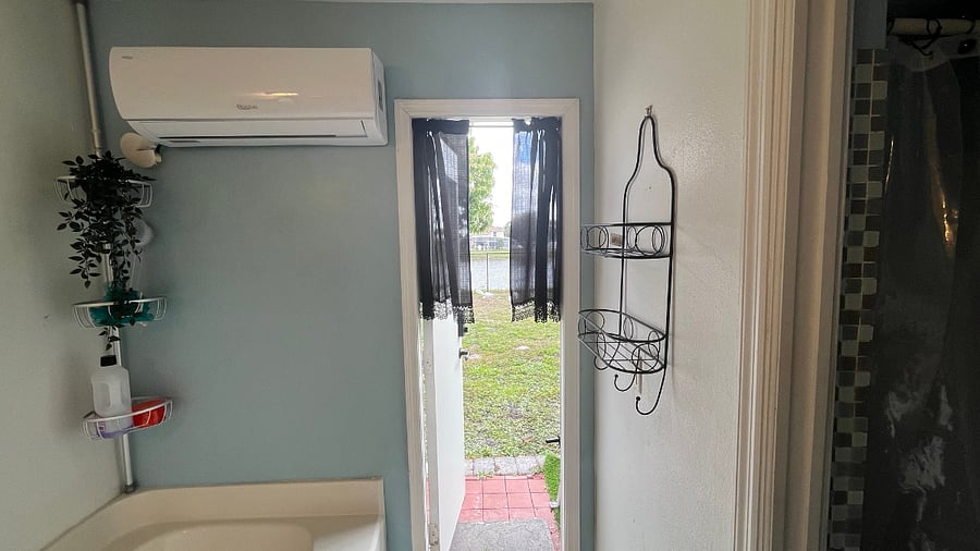 Exterior door to backyard with pond view.