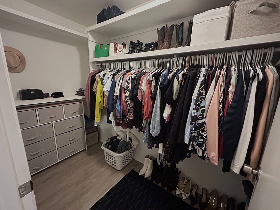 Huge walk in closet with more space behind the door.
