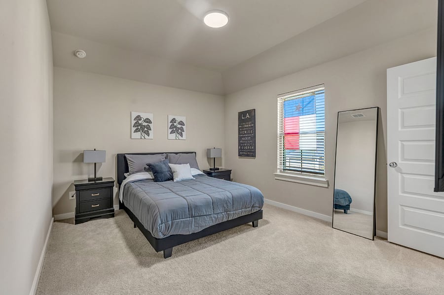 Guest Bedroom 1 (upstairs) with a queen size bed, dresser, walk in closet, ensuite, and 55" smart tv