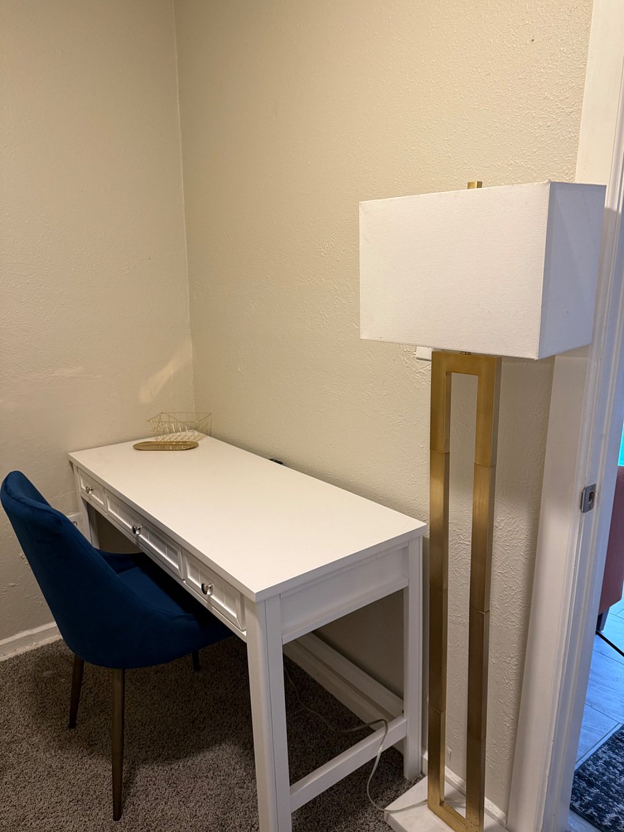 Desk with electric powered table for convience of charging/using devices.