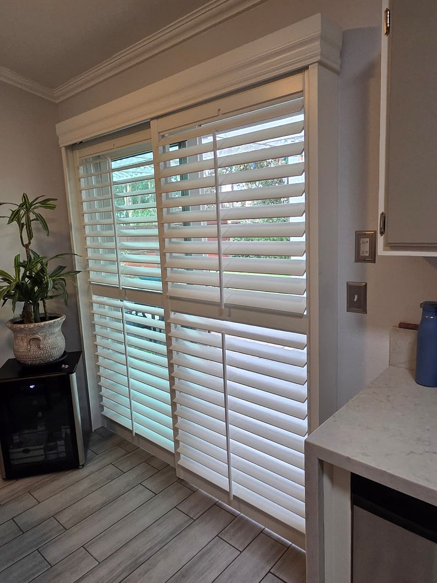 Kitchen sliding glass door leads to backyard area.