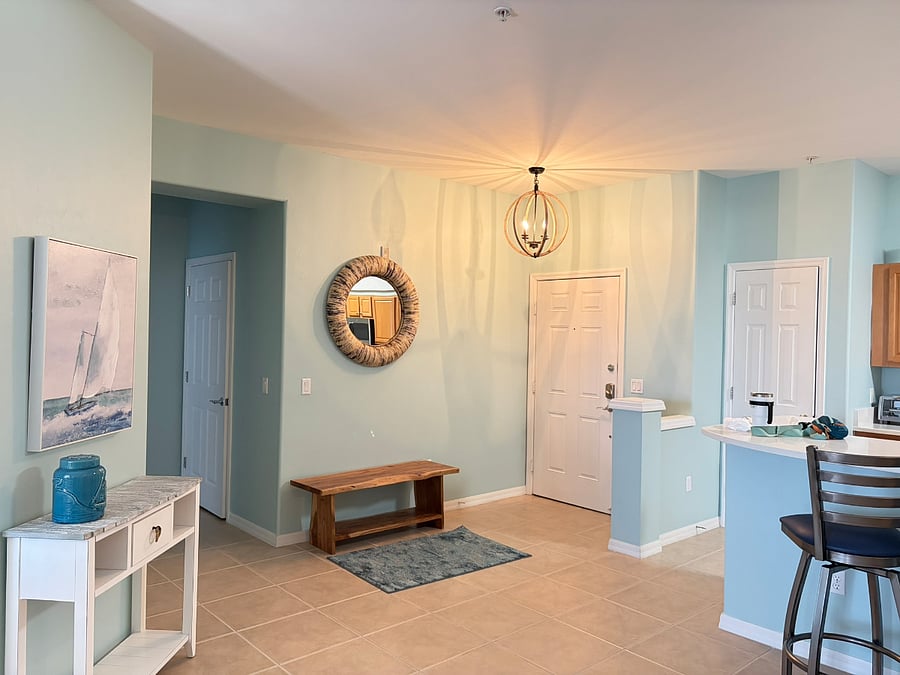 Entrance with hallway leading to guest bath and guest bedrooms.