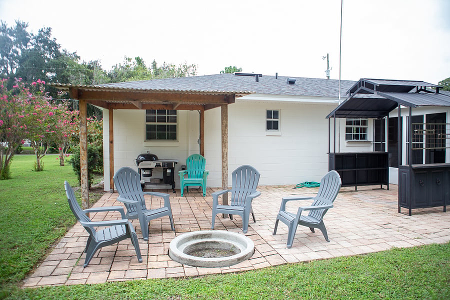 The back patio is ready for you to relax. Enjoy the fire pit and grill.