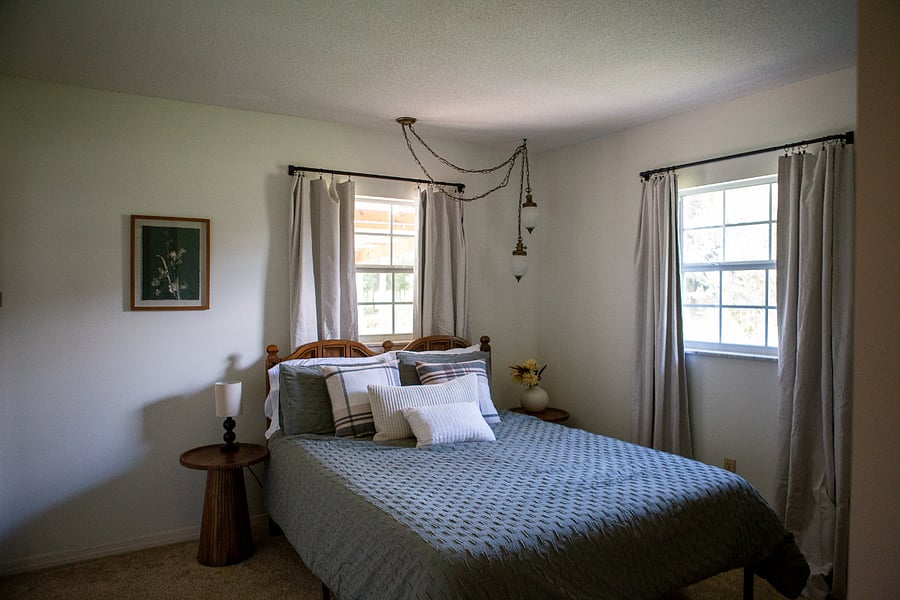 The primary bedroom has a comfortable queen size bed, en suite bathroom, and blackout curtains.