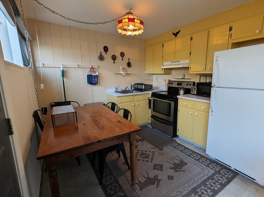 Full kitchen with farm style wooden table