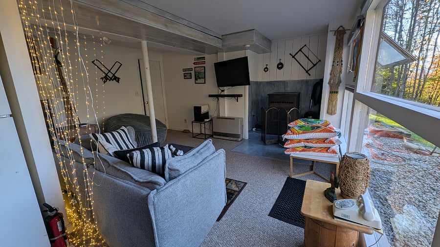 Living room with sofa and bean bag chair. Plenty of lighting and entertainment. Ottoman to rest your feet and extra blanket inside.
