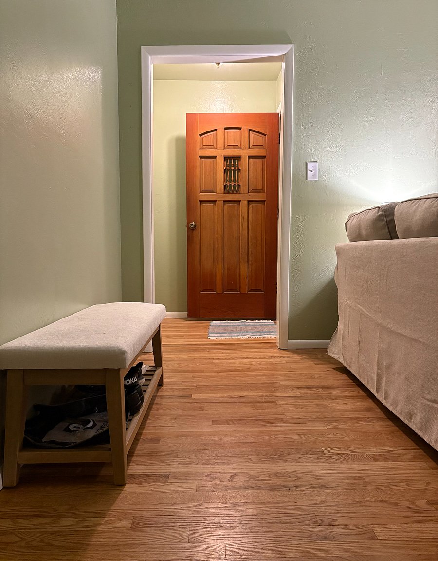 Front door with coat closet and shoe bench.