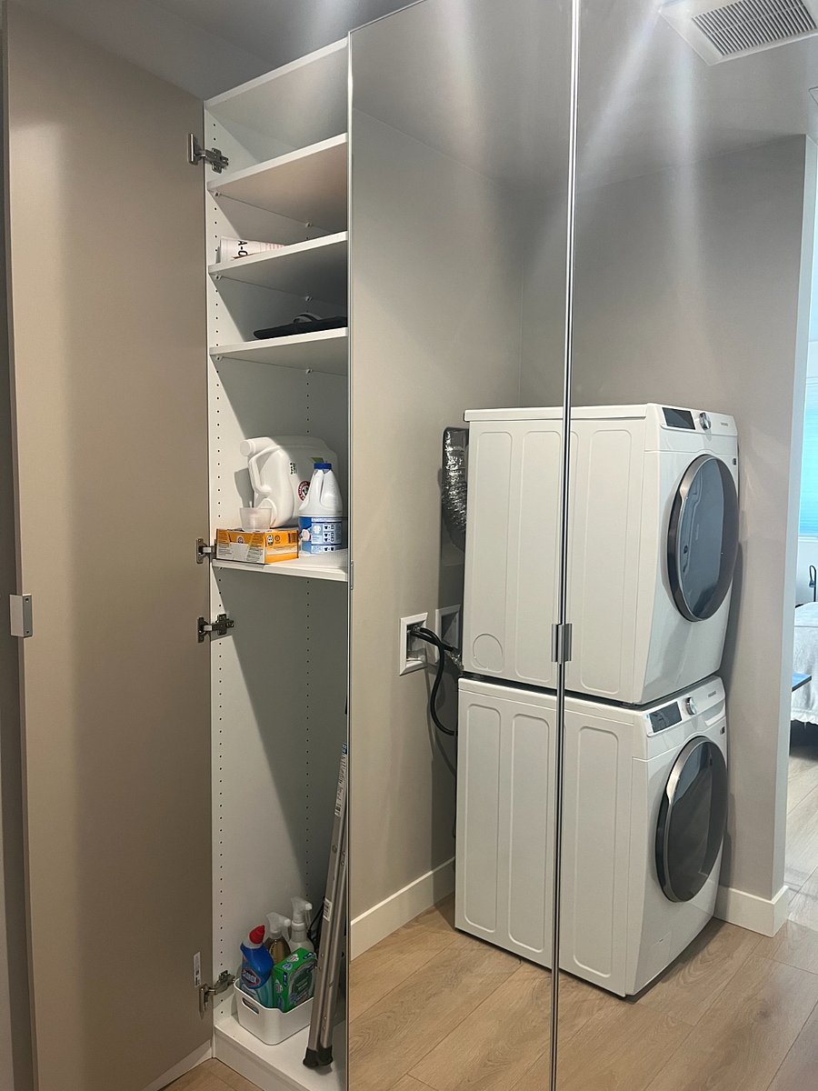 Well equipped cleaning closet with Dyson vacuum cleaner