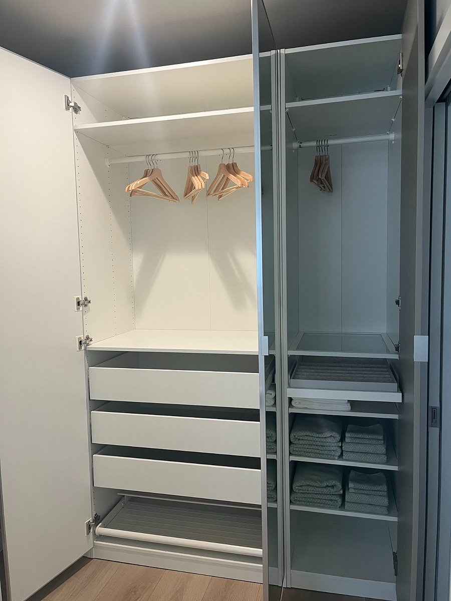 Ample closet space with jewelry panel, drawers, and show racks