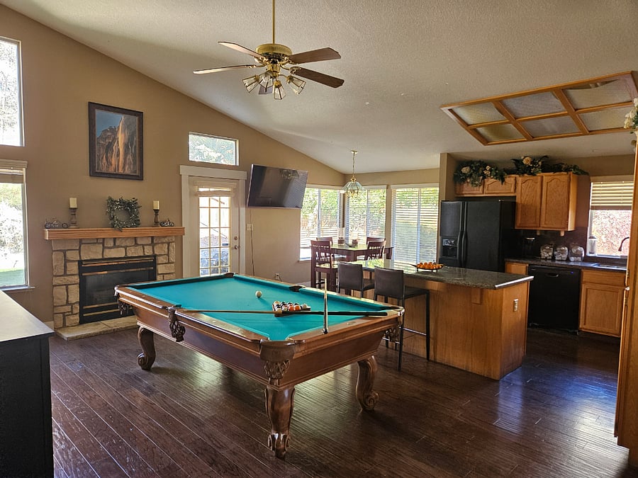 Upgraded kitchen with breakfast nook. Entertainment center featuring a pool table and a smart tv. The kitchen is fully furnished with all amenities for the person who likes to cook. Induction stove, granite countertops, and all the accessories you could ever want.