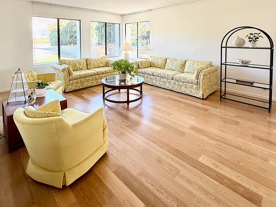 Formal living room with two sofas and two swivel chairs. Faces North to a view of the San Gabriel Mountains.