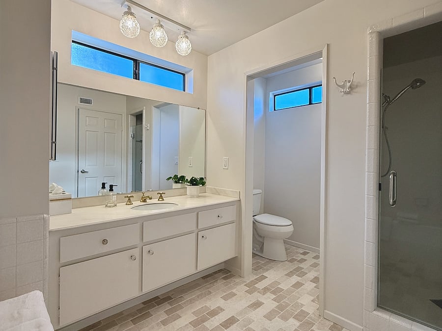Ample light, storage, standalone shower and bathtub.