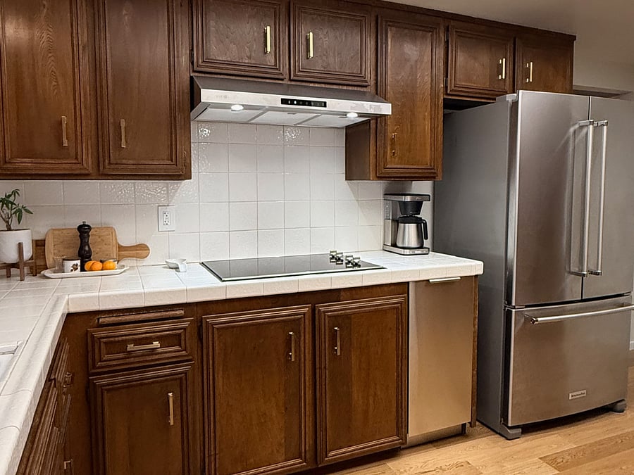 New GE electric glass cooktop and newer Kitchenaid fridge with ice maker and filtered water.