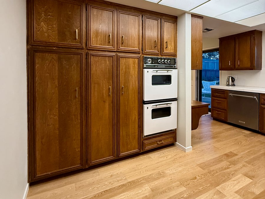 View as you enter kitchen from the hall or family room. Pantry storage cabinets.
