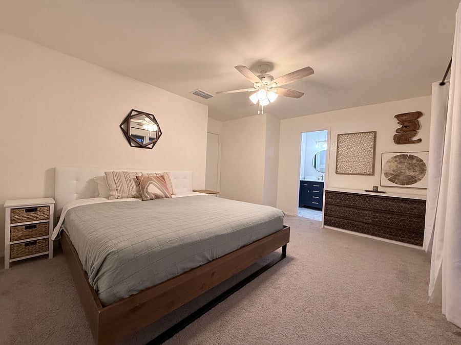 Room with king bed and full bathroom.