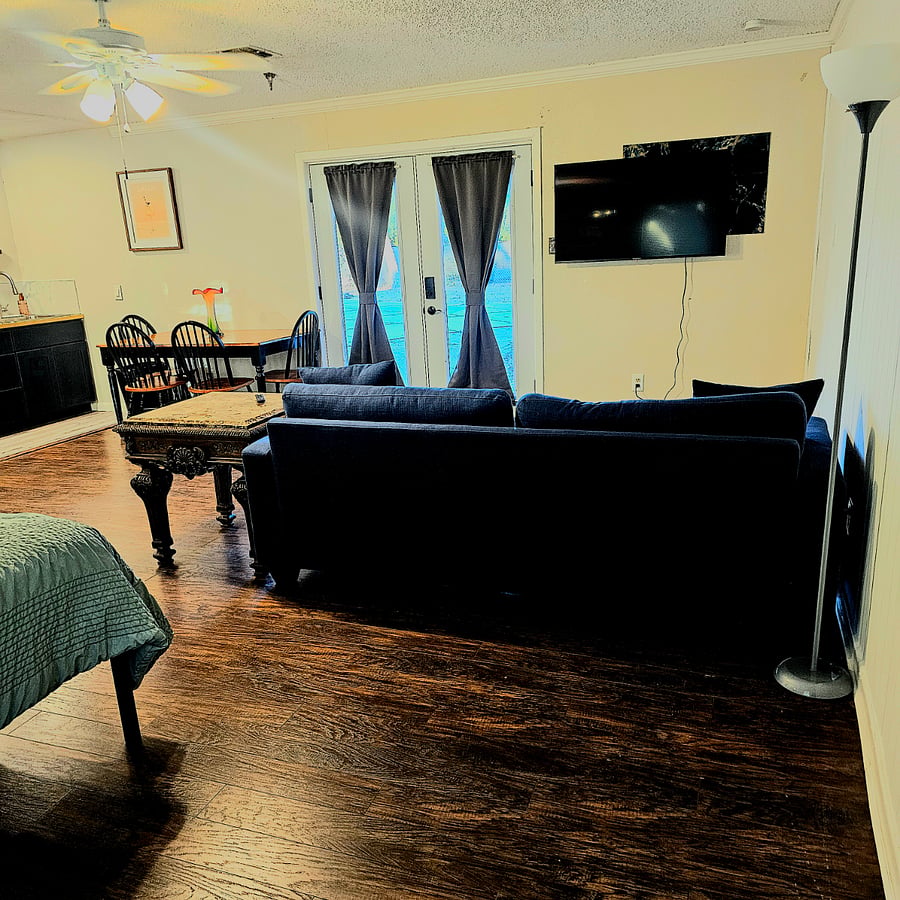 Dining table with 4 chairs
French doors with blackout privacy curtains.