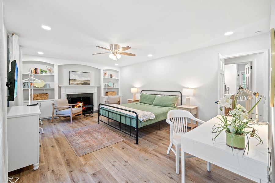 Bedroom #1 on Main Floor - King Bed - Dresser - TV - Memory Foam Mattress - Desk - Sitting Area - Nightstiands - Lamps - Ceiling Fan.  Flames are shown in the fireplace but we do not allow fires in the fireplace.  Room for a twin bed (upon request).