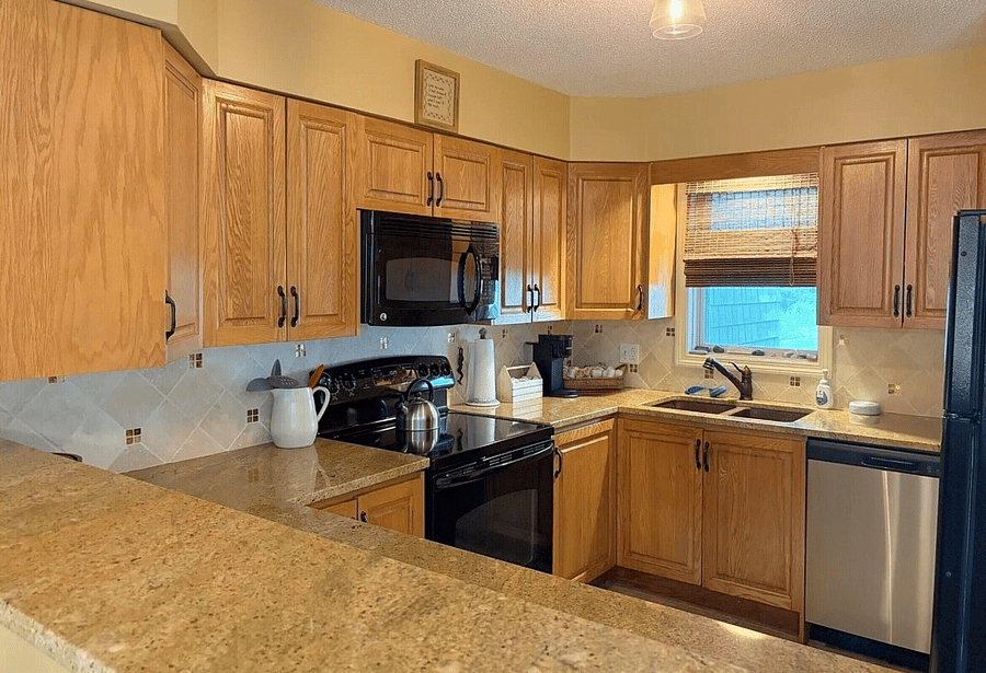 Kitchen with full compliment of appliances, cookware, cutlery and dishes. Dishwasher and refrigerator with icemaker.