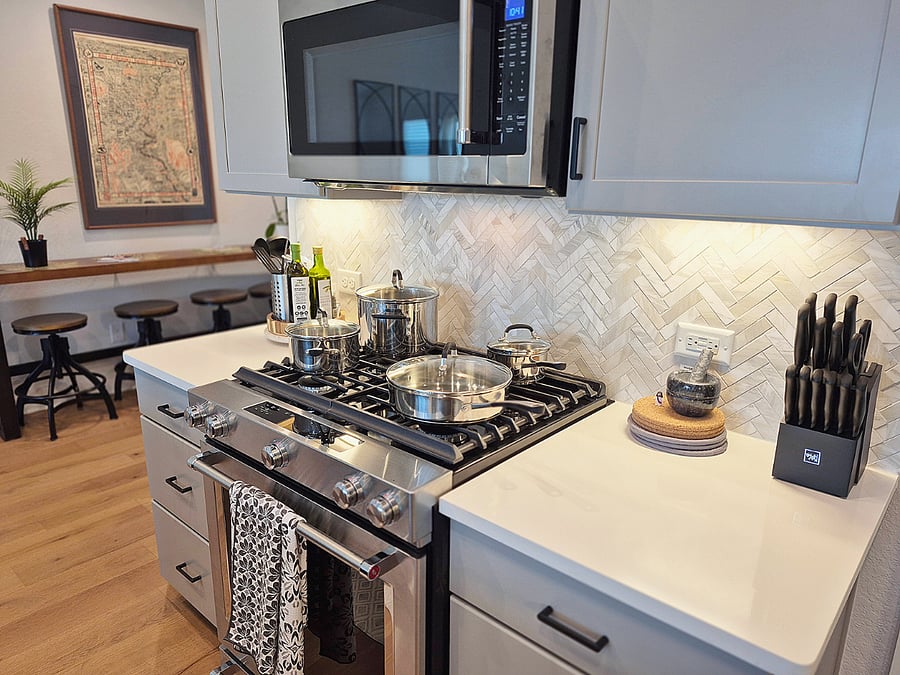 Fully stocked kitchen with all the pots, pans, flat and stemware needed to host dinner.