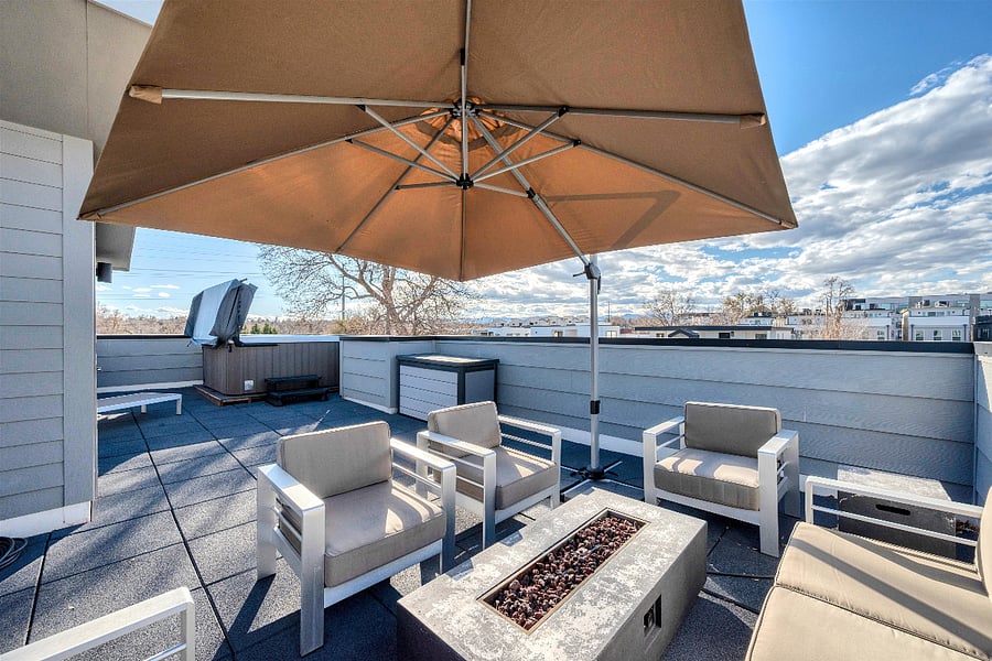 Rooftop: seating area w/ storage, lounge chair and hot tub