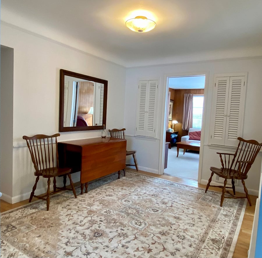 Dining room with drop leaf table that easily seats eight or tucks away for two! Built in storage cabinets and curio shelving. Hardwood floors.