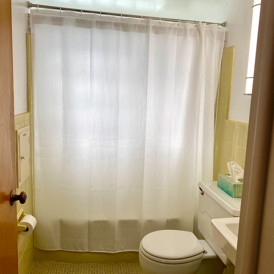 Main Bathroom - Original tile. Recently painted and new light fixtures provide dimmable lighting. Laundry chute to basement.