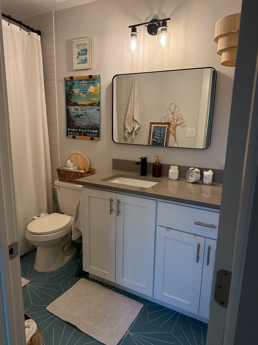 Full bathroom with all the necessities - cleaning supplies, hair dryer, lots of towels and washcloths.