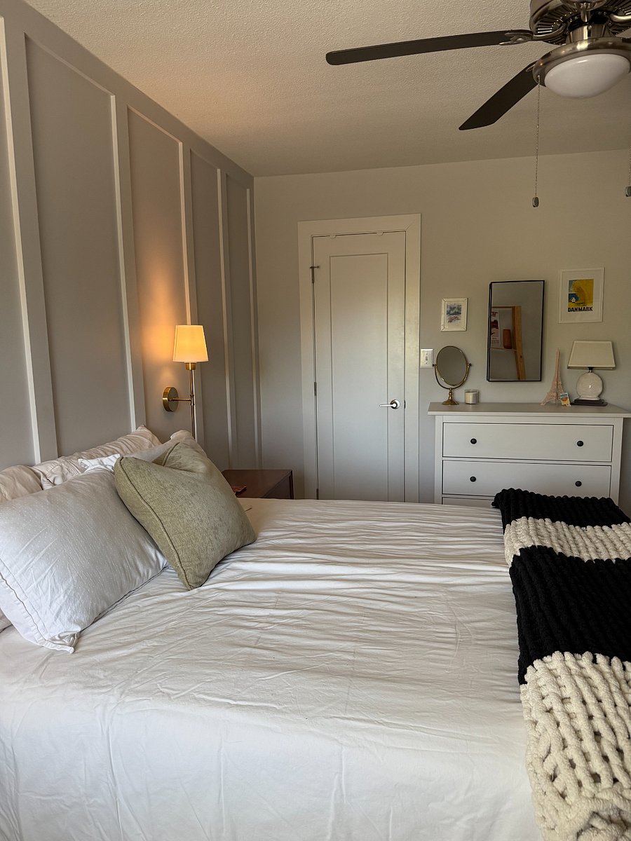 Primary bedroom has a queen bed and individual duvets - one for each person.