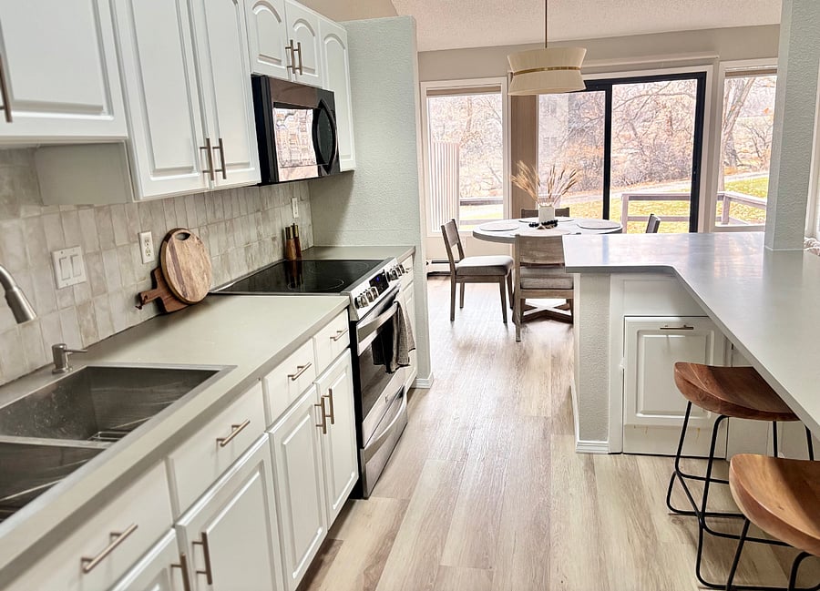 Open Concept Kitchen with flows into dining area and onto back deck