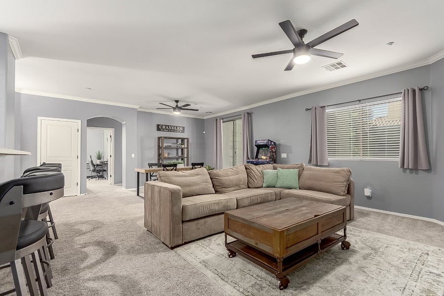 Open concept living space plus arcade game with direct entry to private patio overlooking greenbelt
