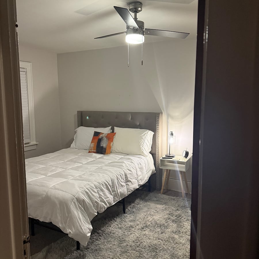 Large bedroom with king size bed, and mounted smart TV