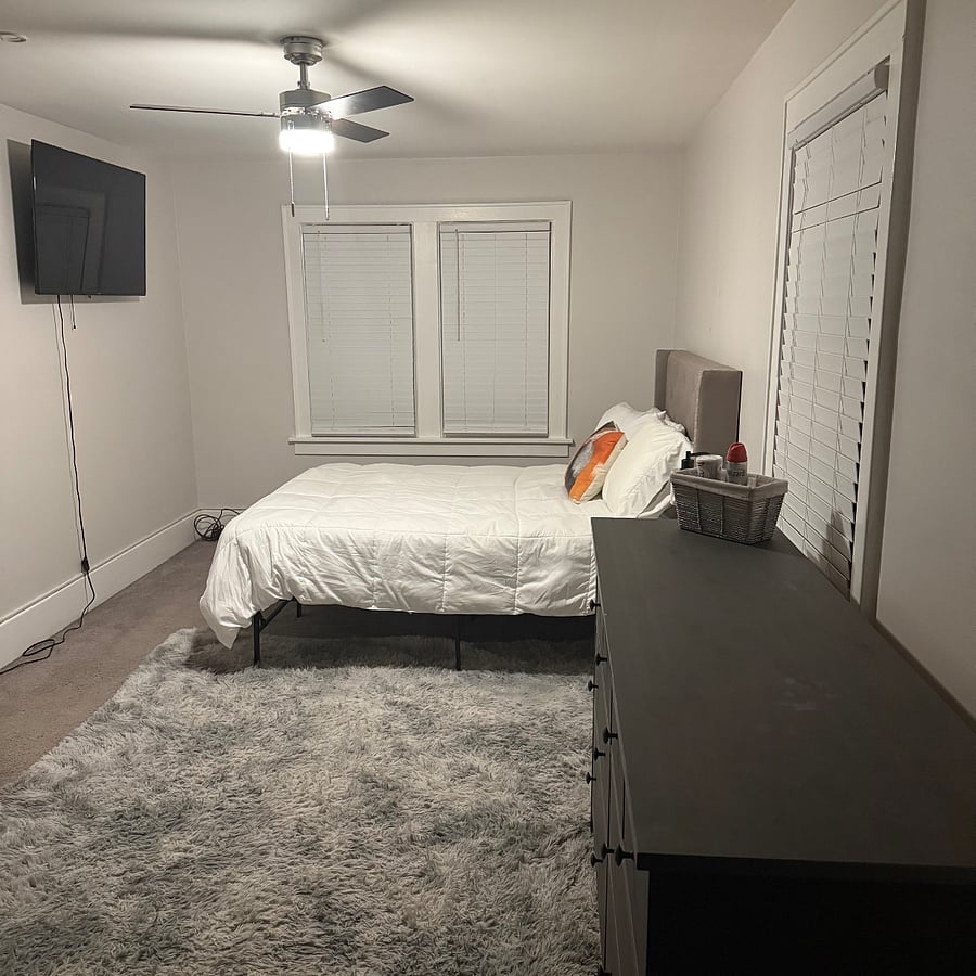 Large bedroom with king-size bed and mounted smart TV