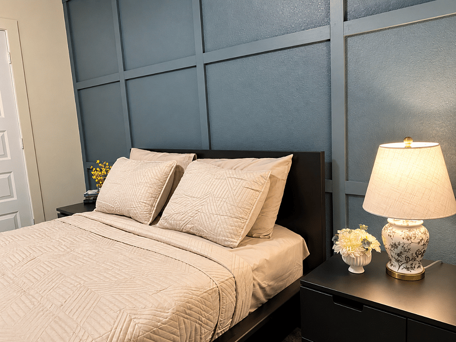 rest comfortably in a queen bed with fresh linens,bedside table and lamp,and a calm,welcoming atmosphere