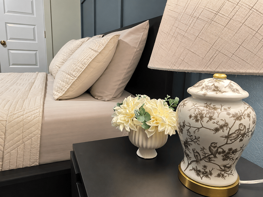 cozy queen bed with fresh linens,bedside lighting,and thoughtful touches for a comfortable stay