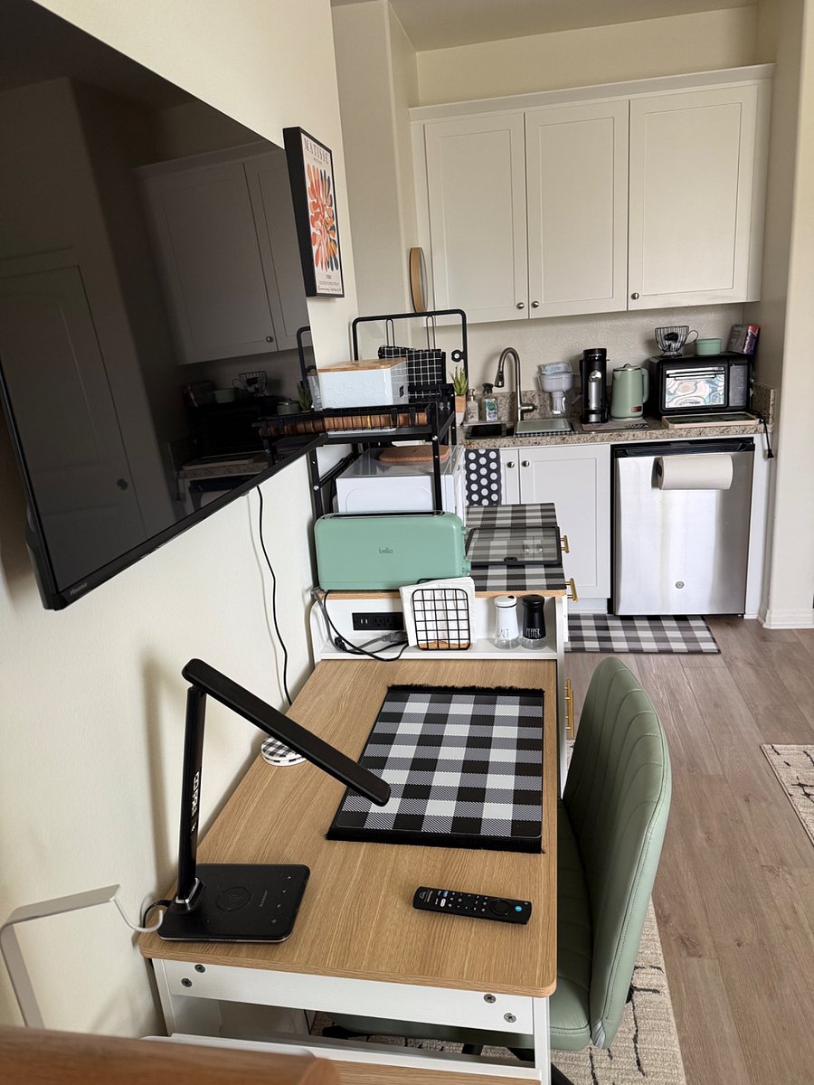 TV mounted above table. Desk lamp with phone charger . USB ports .