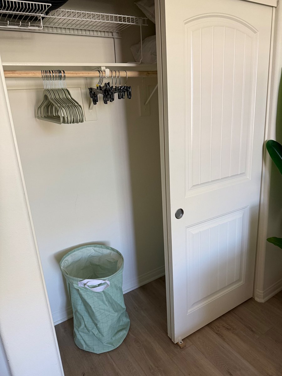 Closet with hangers and laundry hamper