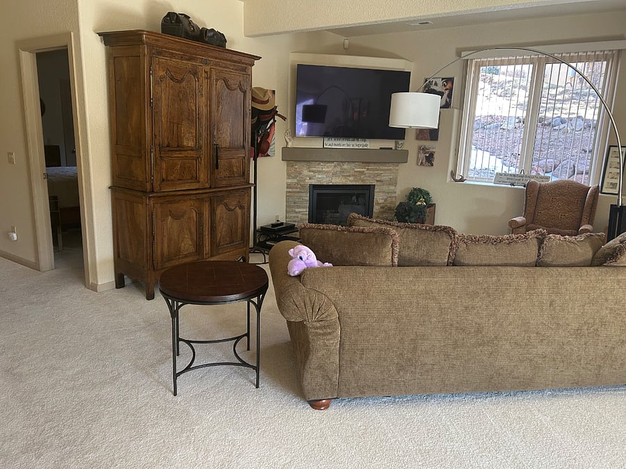 Large open plan living space with large television. The door to your bedroom is the open one behind the tall cabinet.