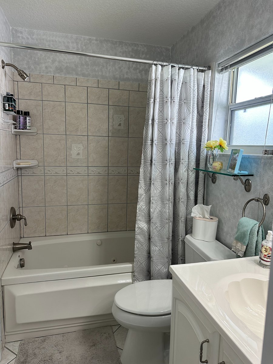 Private, en-suite bath features spa tub, shower, large vanity with storage.