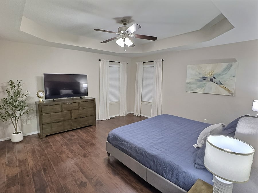 Bedroom 1 with king bed and 55" Smart TV, large walk-in closet