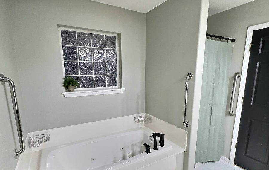 Bedroom 1 bathroom with double vanity, jacuzzi tub and shower