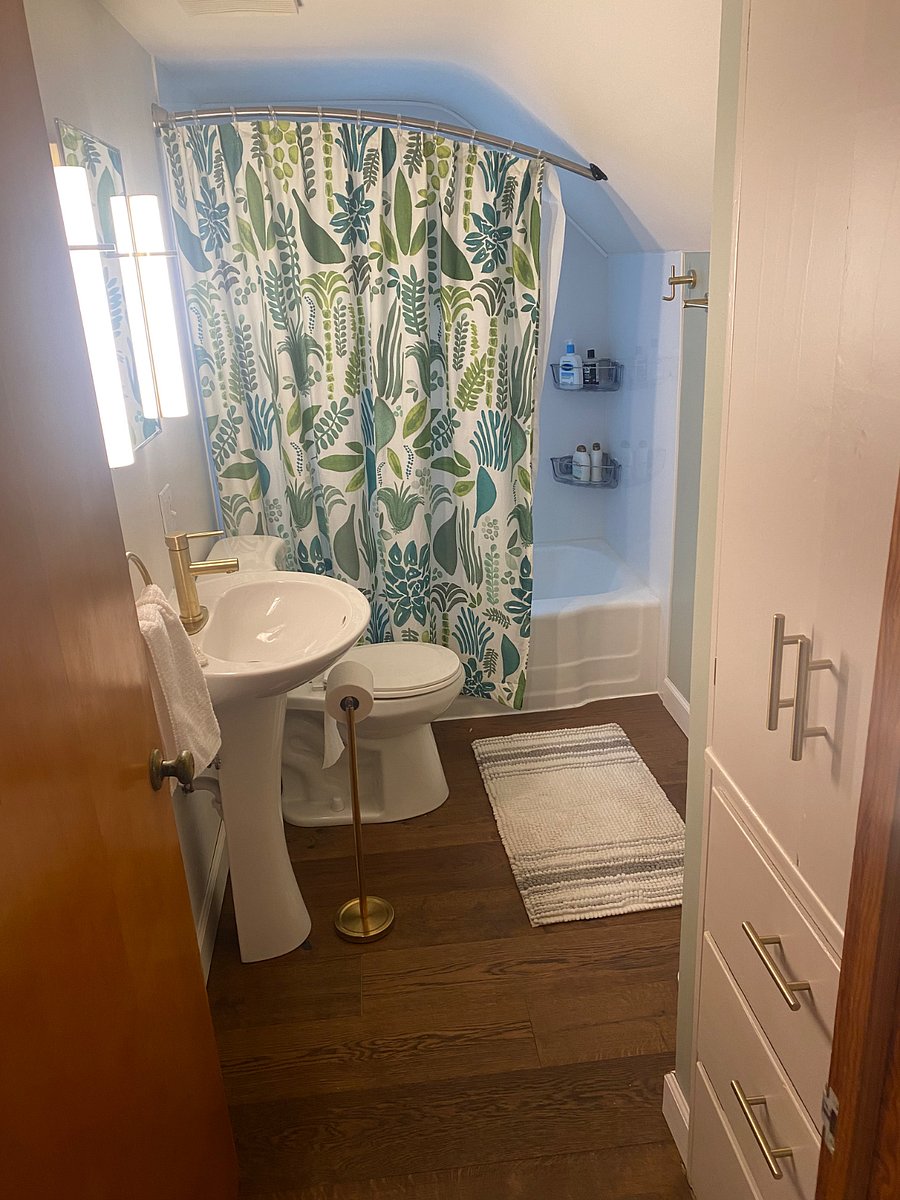 Bathroom freshly renovated with new shower surround, shower head/tub spout, sink, toilet, and dimmable sconce lighting. Plenty of storage with built-in cabinet/drawers and hidden vanity shelves.