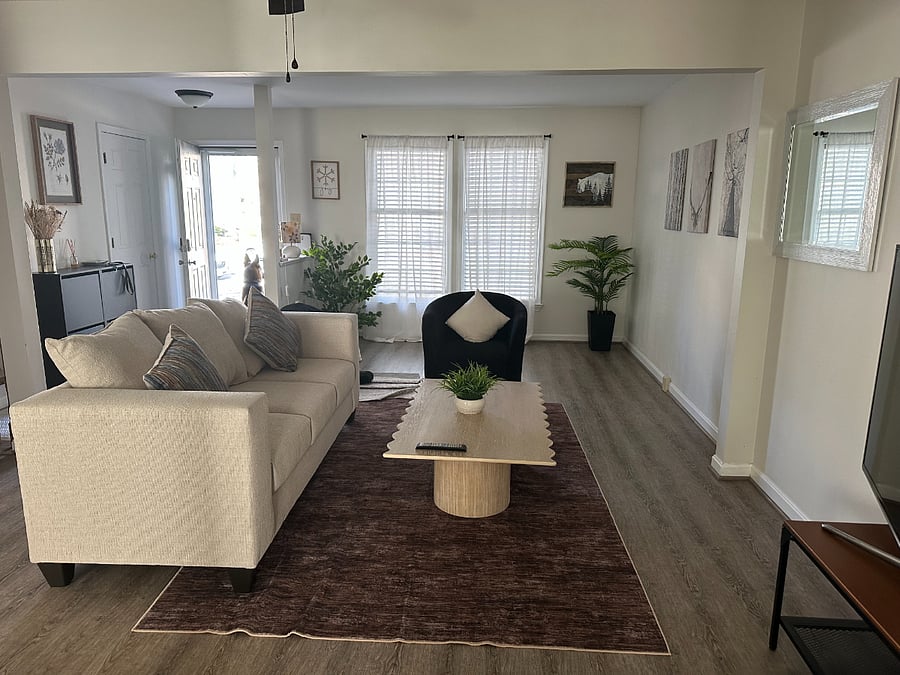 comfy couch and thought provoking coffee table. In the living room you also have a two shoe racks and also in the far left a half bathroom for guests.